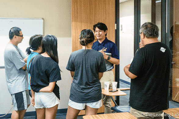 A mentor talking with a group of students