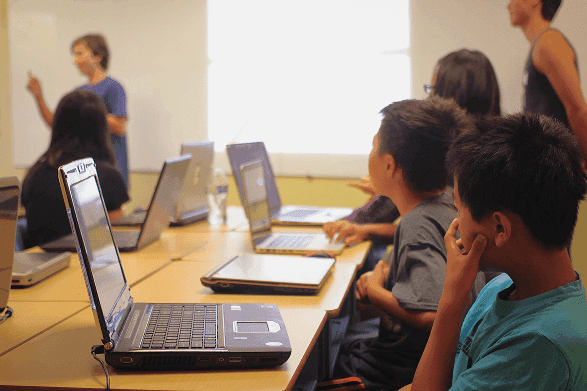 Students focused on their laptops in a quiet room