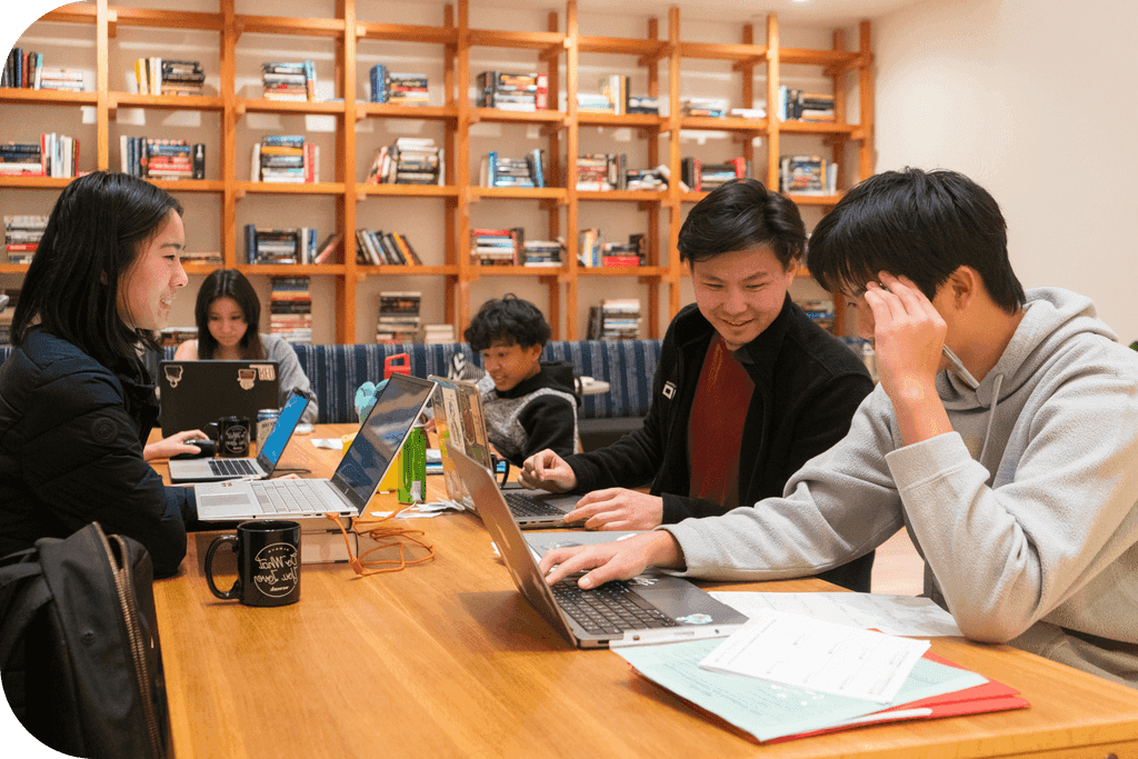 Students studying together at a long table in the Learning Lab