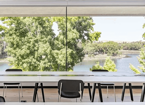 A bright office meeting room with a garden view