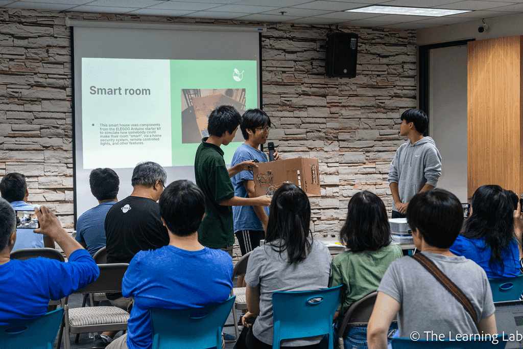 Students listening to a research presentation
