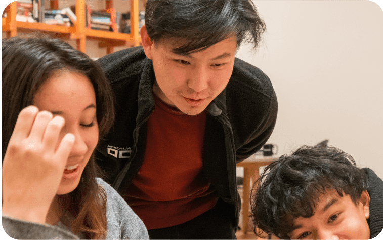 Daniel helping students with their work