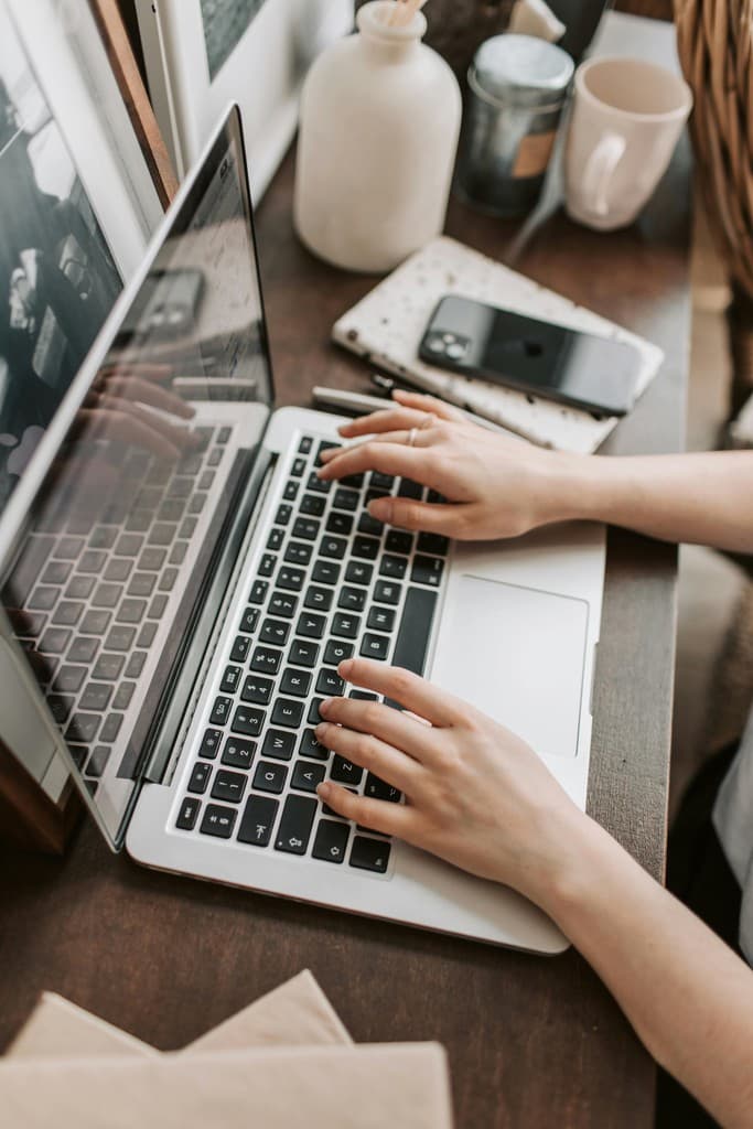 A student typing an essay on a laptop