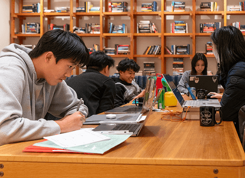 A student working through notes at a desk